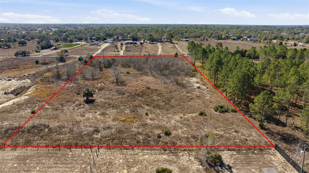 An aerial view shows a large, rectangular, undeveloped plot of land outlined in red — SWEET GUM ROAD, BROOKSVILLE, FL