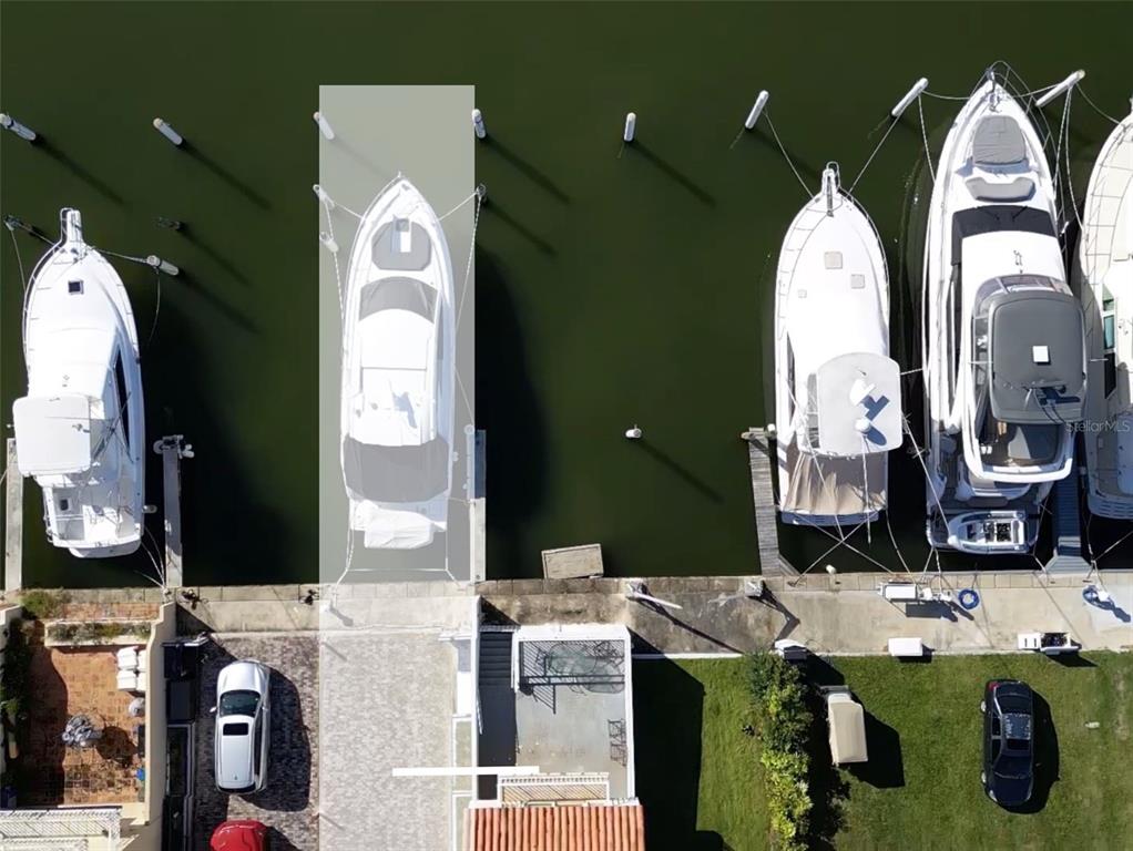 An aerial view shows several yachts docked at a waterfront property with paved parking areas — 9 ISLA SAN MIGUEL UNIT 9, HUMACAO, PR