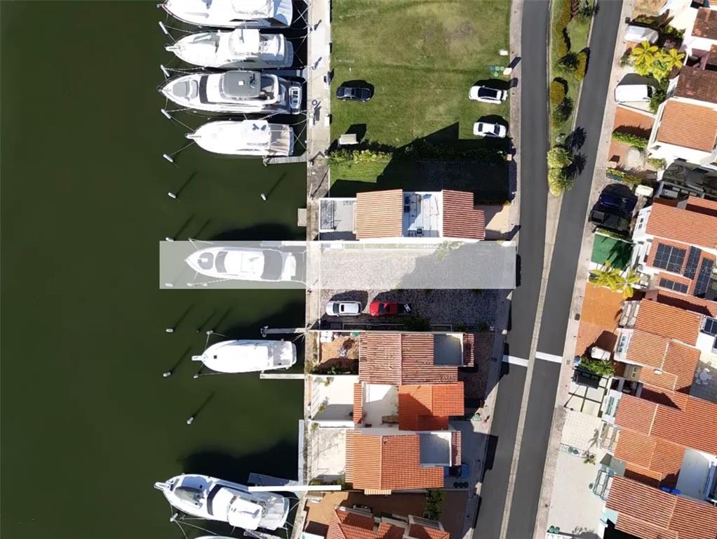 An aerial view shows a row of waterfront townhouses with private boat slips and docks — 9 ISLA SAN MIGUEL UNIT 9, HUMACAO, PR