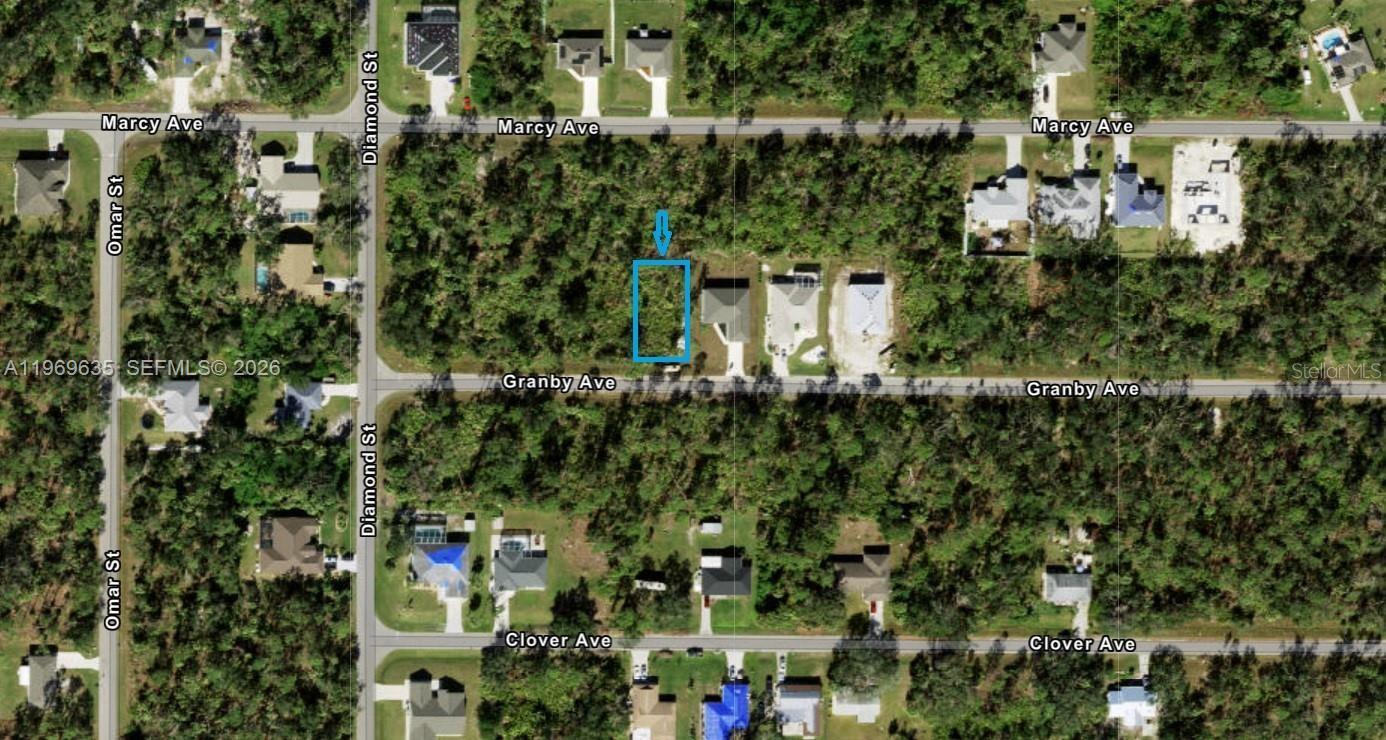 This is an aerial map showing a vacant lot highlighted in blue between residential streets — PORT CHARLOTTE, FL