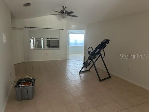 A room with light-colored tile flooring, a ceiling fan, and an inversion table — 2416 WATERFORD COURT, PALMETTO, FL