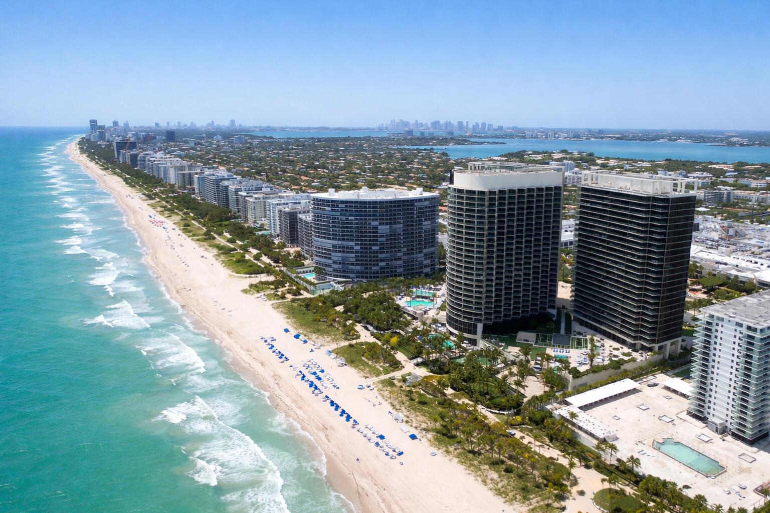 An aerial view of a sandy beach lined with high-rise residential buildings along the coast — 9705 Collins Avenue # 1104n, Bal Harbour FL 33154, BAL HARBOUR, FL