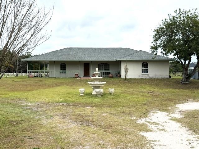 A single-story house with a green roof and a front yard fountain — 2416 Vance Ave, Lorida FL 33857, LORIDA, FL