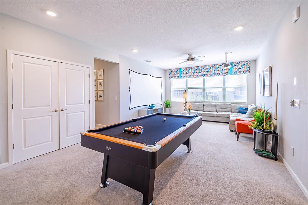 A game room features a pool table, a projector screen, and a sectional sofa — 2567 SHANTI DRIVE, KISSIMMEE, FL