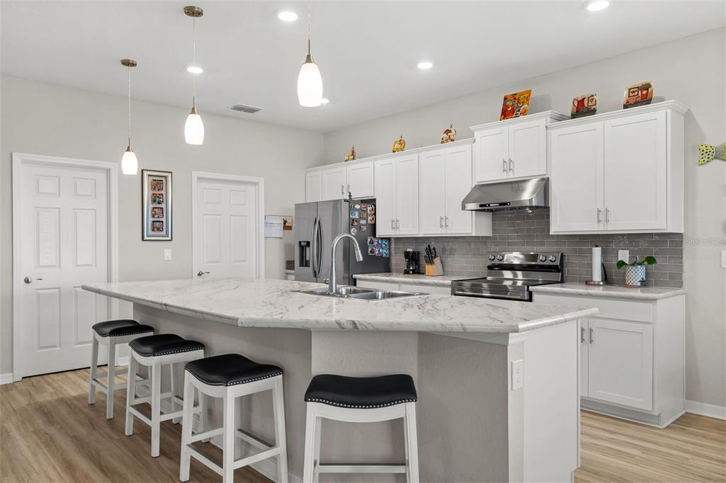 A single-story house with a two-car garage, stone accents, and a front entrance — 1553 FLEUR DRIVE, DAVENPORT, FL