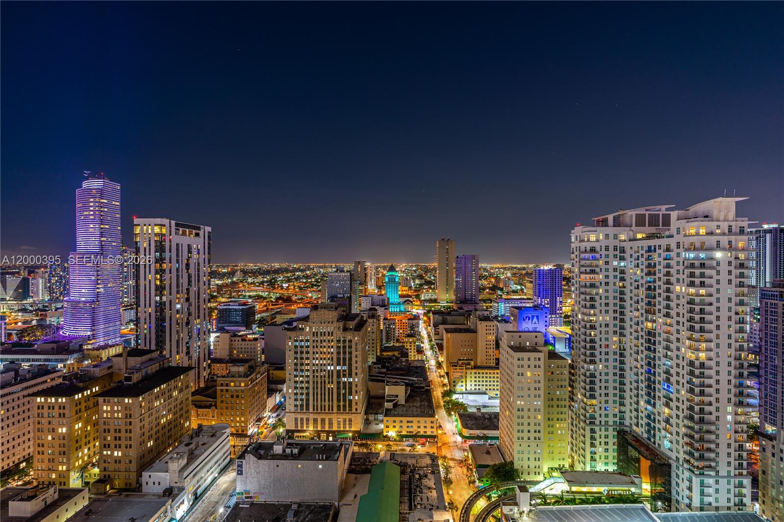 An elevated night view of the Miami skyline featuring illuminated skyscrapers and city streets — 50 Biscayne Blvd # 3601, Miami FL 33132, MIAMI, FL