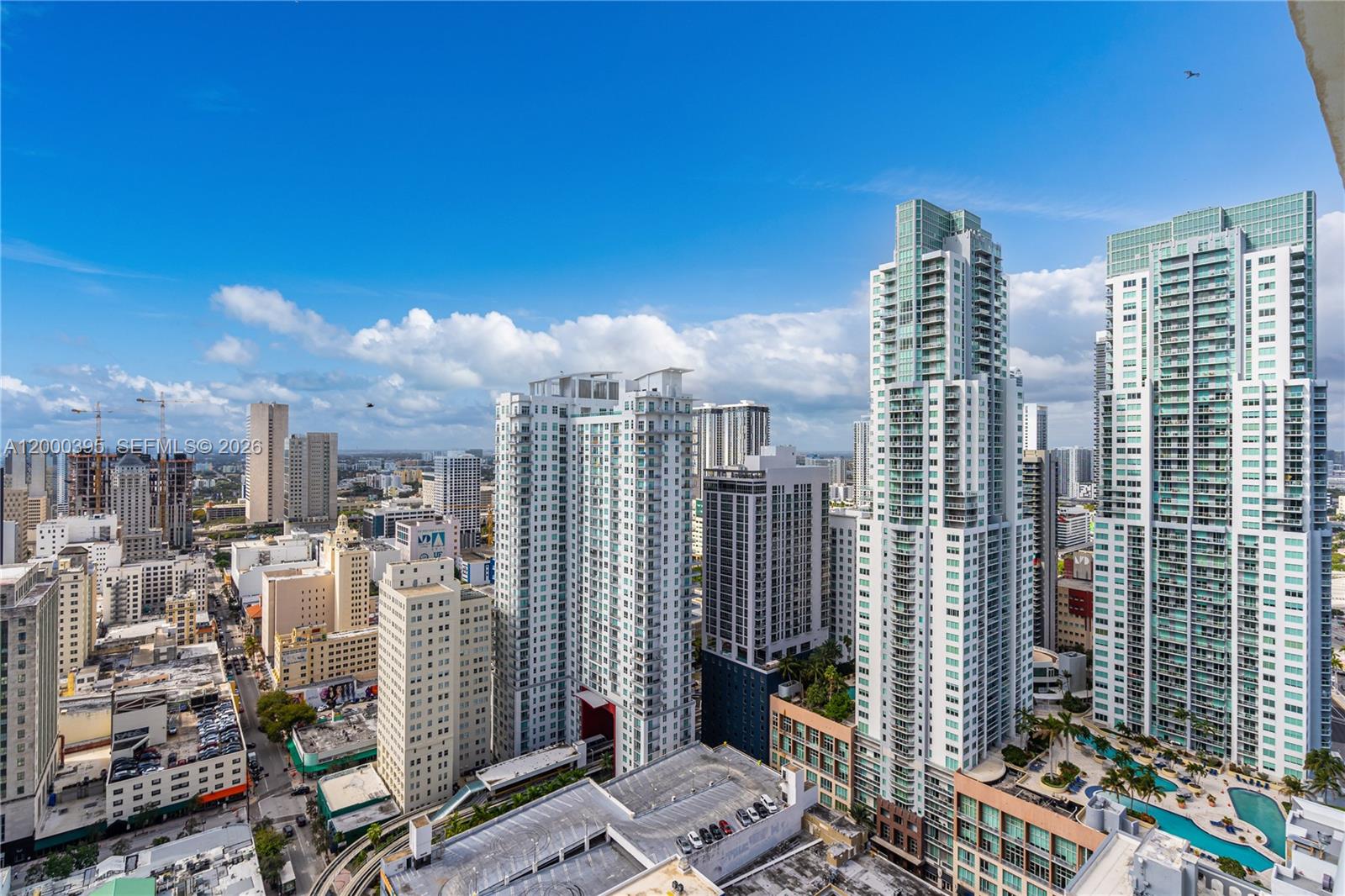 An elevated view of a dense urban skyline featuring numerous high-rise residential and commercial buildings — 50 Biscayne Blvd # 3601, Miami FL 33132, MIAMI, FL