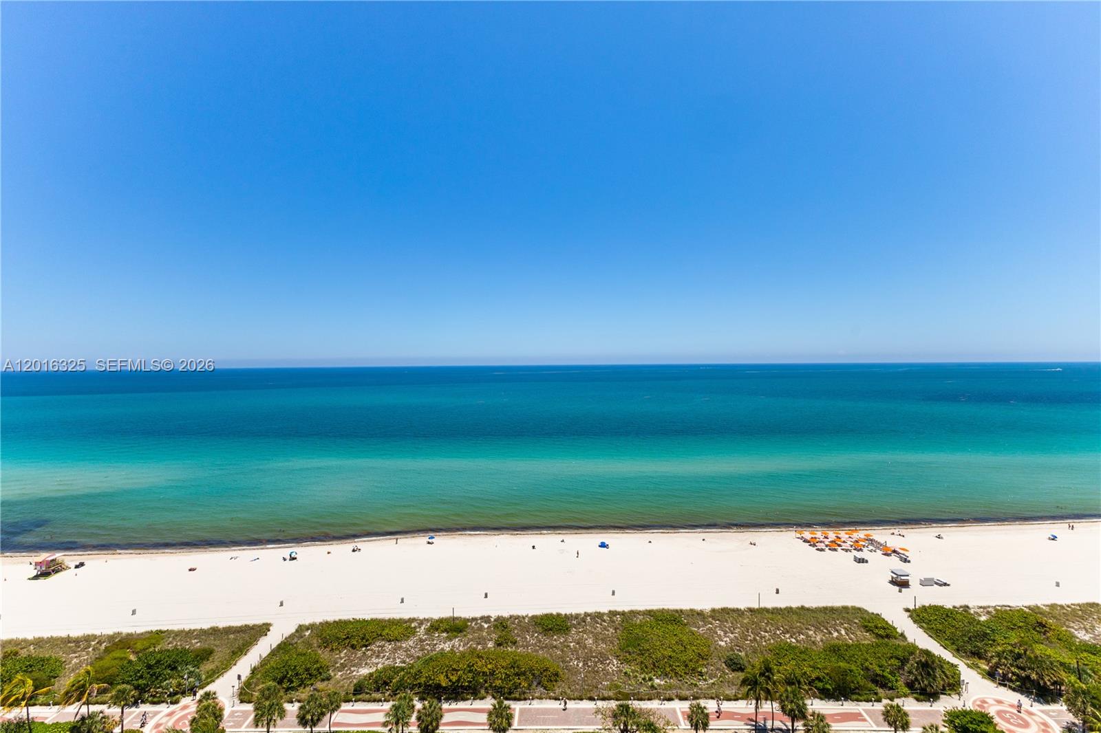 An elevated view of a sandy beach and the ocean under a clear blue sky — 2555 Collins Ave # 2205, Miami Beach FL 33140, MIAMI BEACH, FL
