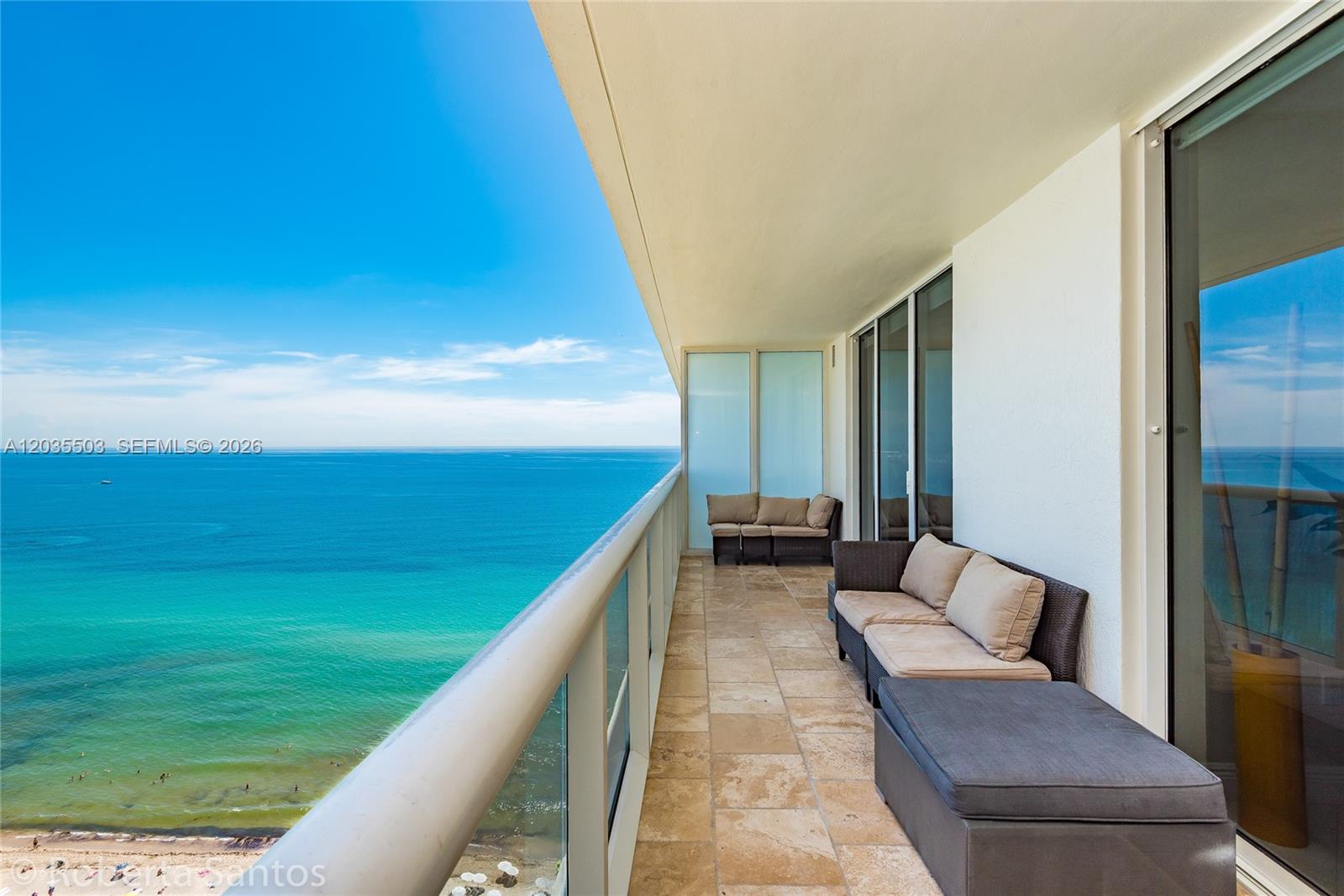 A balcony with tiled flooring, outdoor furniture, and a panoramic view of the ocean — 1830 S Ocean Dr # 2410, Hallandale Beach FL 33009, HALLANDALE BEACH, FL