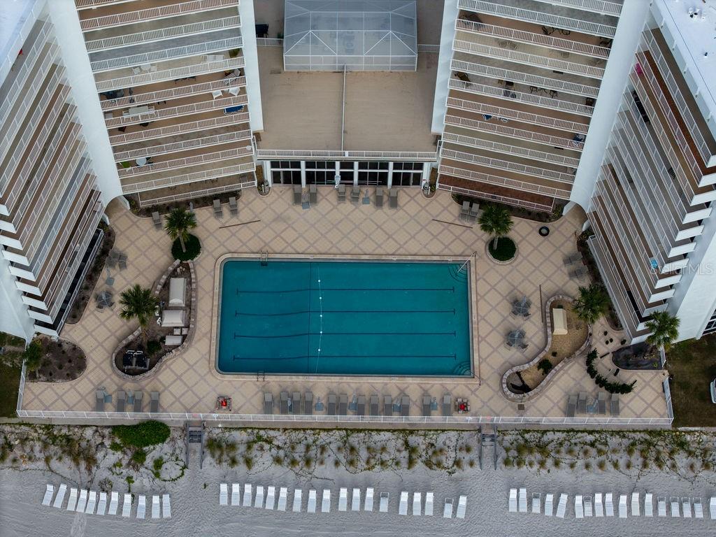 An aerial view of a rectangular swimming pool located between two high-rise apartment buildings — 2295 GULF OF MEXICO DRIVE UNIT 54S, LONGBOAT KEY, FL