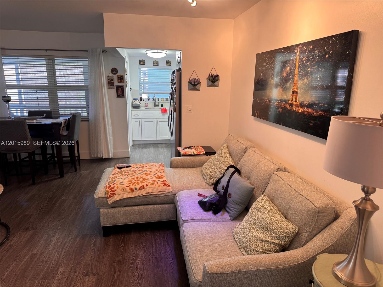 A living room with a sectional sofa, a dining area, and a view into the kitchen — 5300 Washington St # J214, Hollywood FL 33021, HOLLYWOOD, FL
