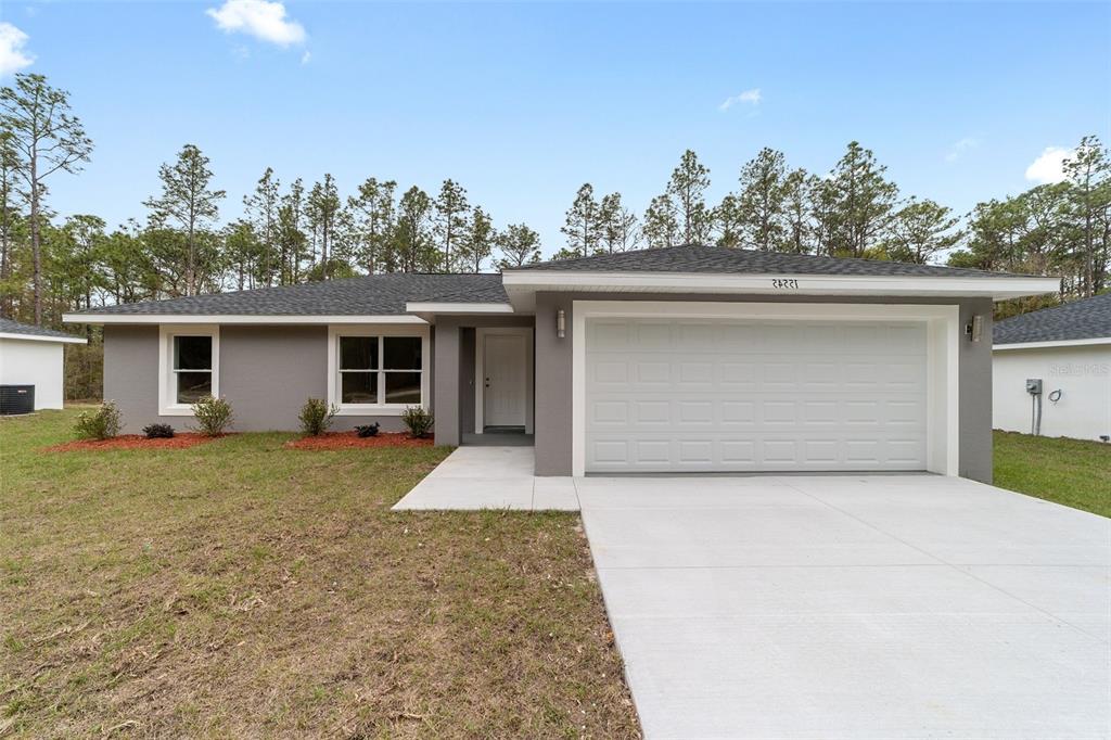A single-story gray house with a two-car garage and a concrete driveway — 3598 SW 151ST COURT, OCALA, FL