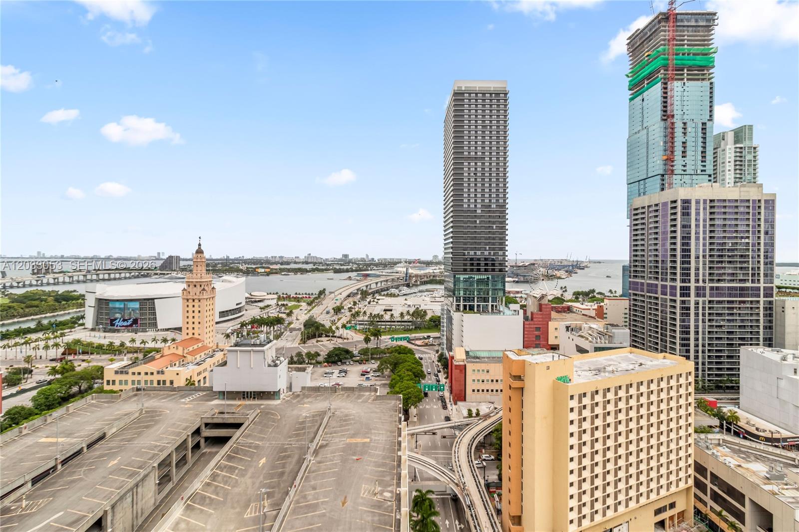 An elevated view of a city skyline featuring skyscrapers, a parking garage, and a stadium — 121 NE 5th St # 2401, Miami FL 33132, MIAMI, FL