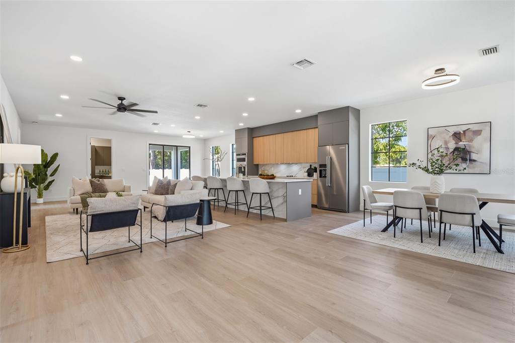 An open-concept living area features a modern kitchen with wood cabinets and a marble island — 3516 21ST AVENUE S, ST PETERSBURG, FL