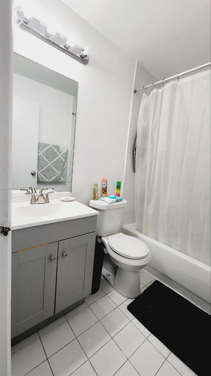 A bathroom features a gray vanity, a white toilet, and a shower-tub combination — 6960 NW 174th Ter # 706, Hialeah FL 33015, HIALEAH, FL