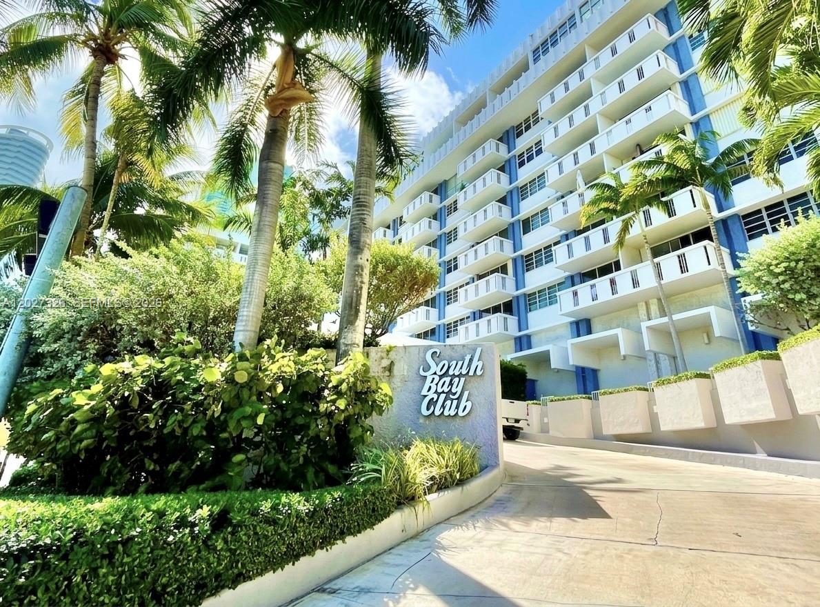 The exterior of the South Bay Club building features a curved driveway and palm trees — 800 West Ave # 924, Miami Beach FL 33139, MIAMI BEACH, FL