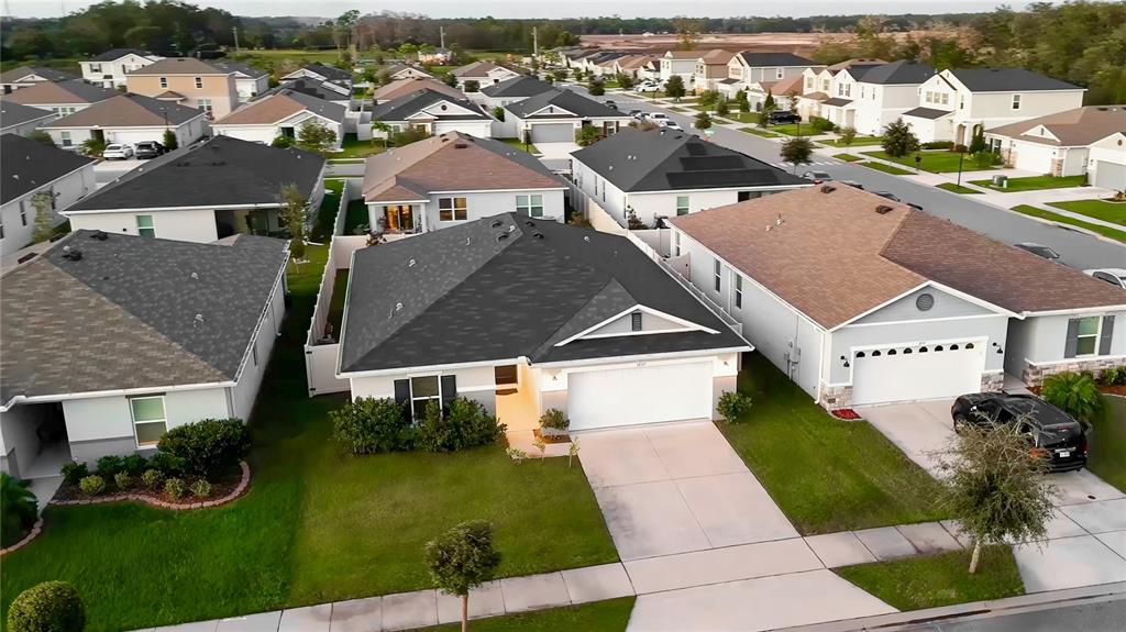 An aerial view shows several suburban houses with driveways and lawns in a residential neighborhood — 1857 GOLD CREST DRIVE, ST CLOUD, FL