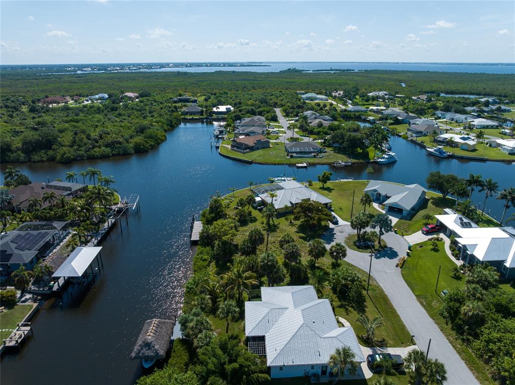 An aerial view shows waterfront homes with boat docks along a canal in Florida — 19188 NEW HAVEN COURT, PORT CHARLOTTE, FL