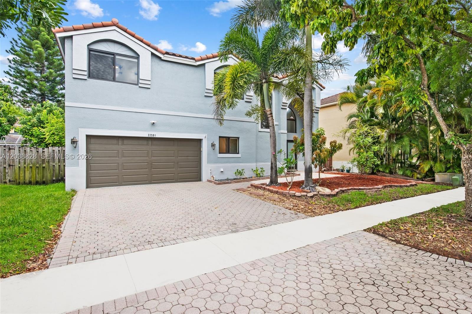 A two-story light blue house features a two-car garage and a paved driveway — 11293 Rhapsody Rd # 0, Cooper City FL 33026, COOPER CITY, FL