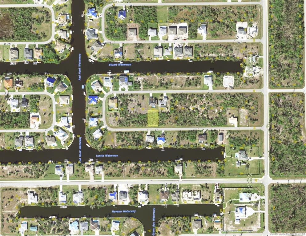 This is an aerial map showing residential lots and waterways in a suburban neighborhood — 15723 STUART CIRCLE, PORT CHARLOTTE, FL