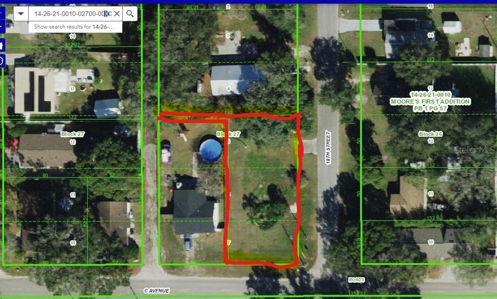 This is a satellite map showing a highlighted vacant residential lot at a street corner — 4741 18TH STREET, ZEPHYRHILLS, FL