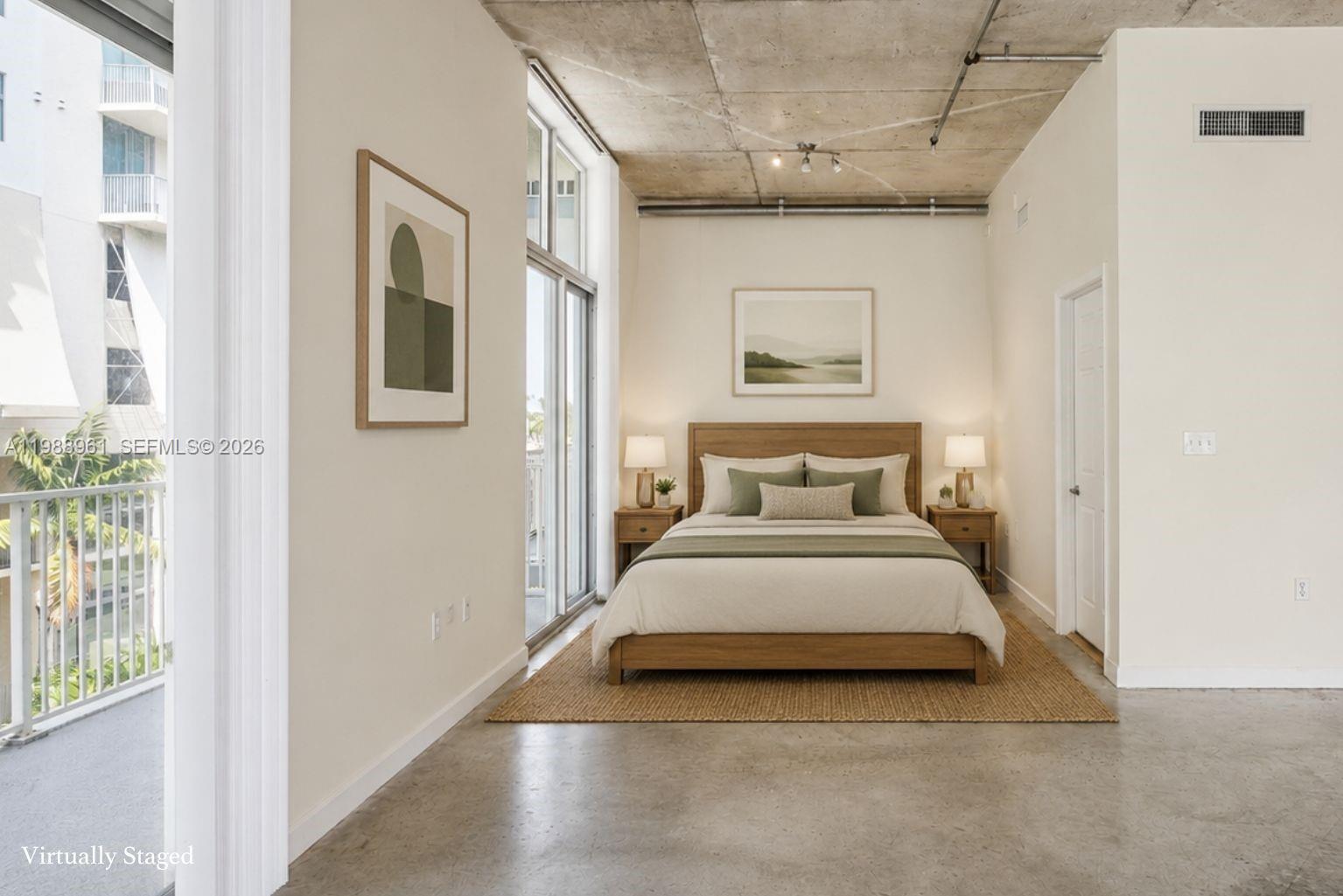This bedroom features a concrete ceiling, polished concrete floors, and a balcony with railings — 2100 Van Buren St # 319, Hollywood FL 33020, HOLLYWOOD, FL