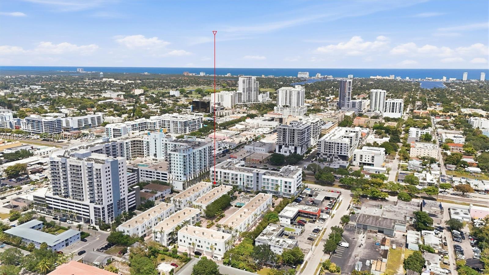 An aerial view shows a dense urban neighborhood with multi-story apartment buildings and surrounding city infrastructure — 2100 Van Buren St # 319, Hollywood FL 33020, HOLLYWOOD, FL