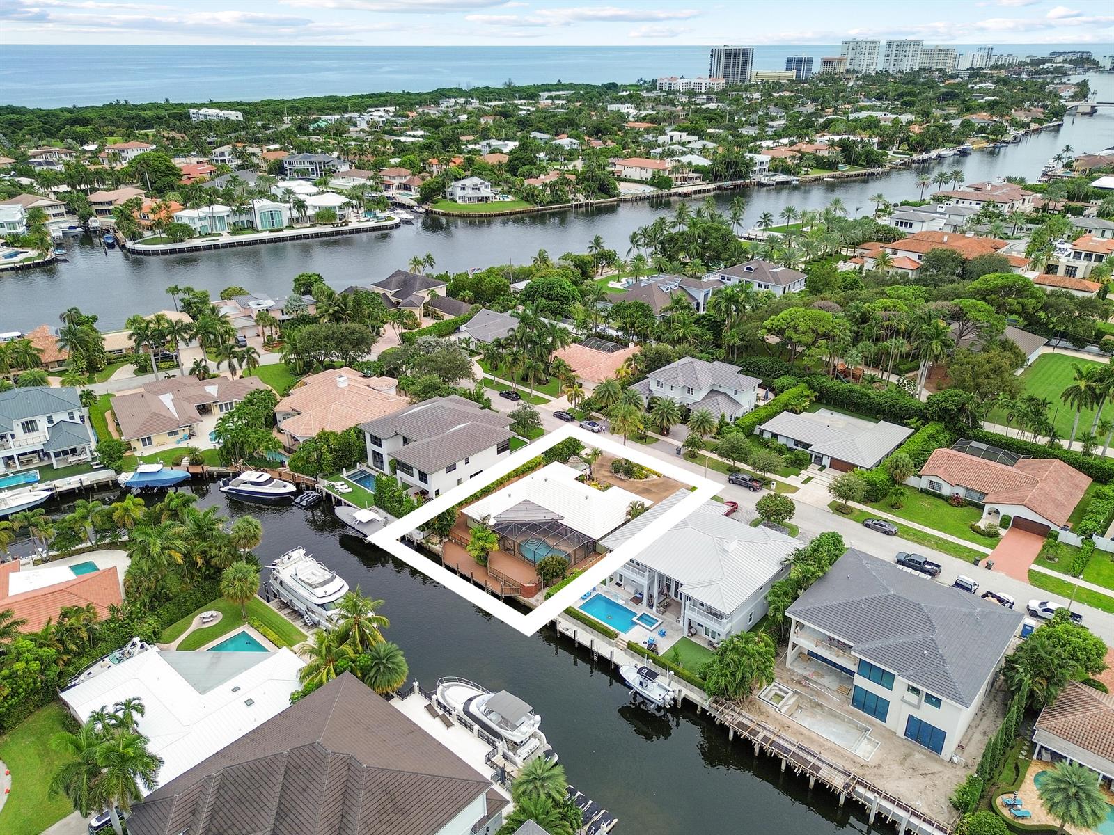 An aerial view shows a waterfront house with a screened pool deck and boat dock — 531 Silver Lane, Boca Raton FL 33432, BOCA RATON, FL