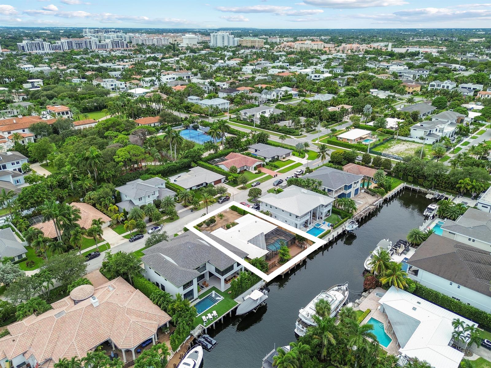 An aerial view shows a waterfront house with a screened pool deck along a canal — 531 Silver Lane, Boca Raton FL 33432, BOCA RATON, FL