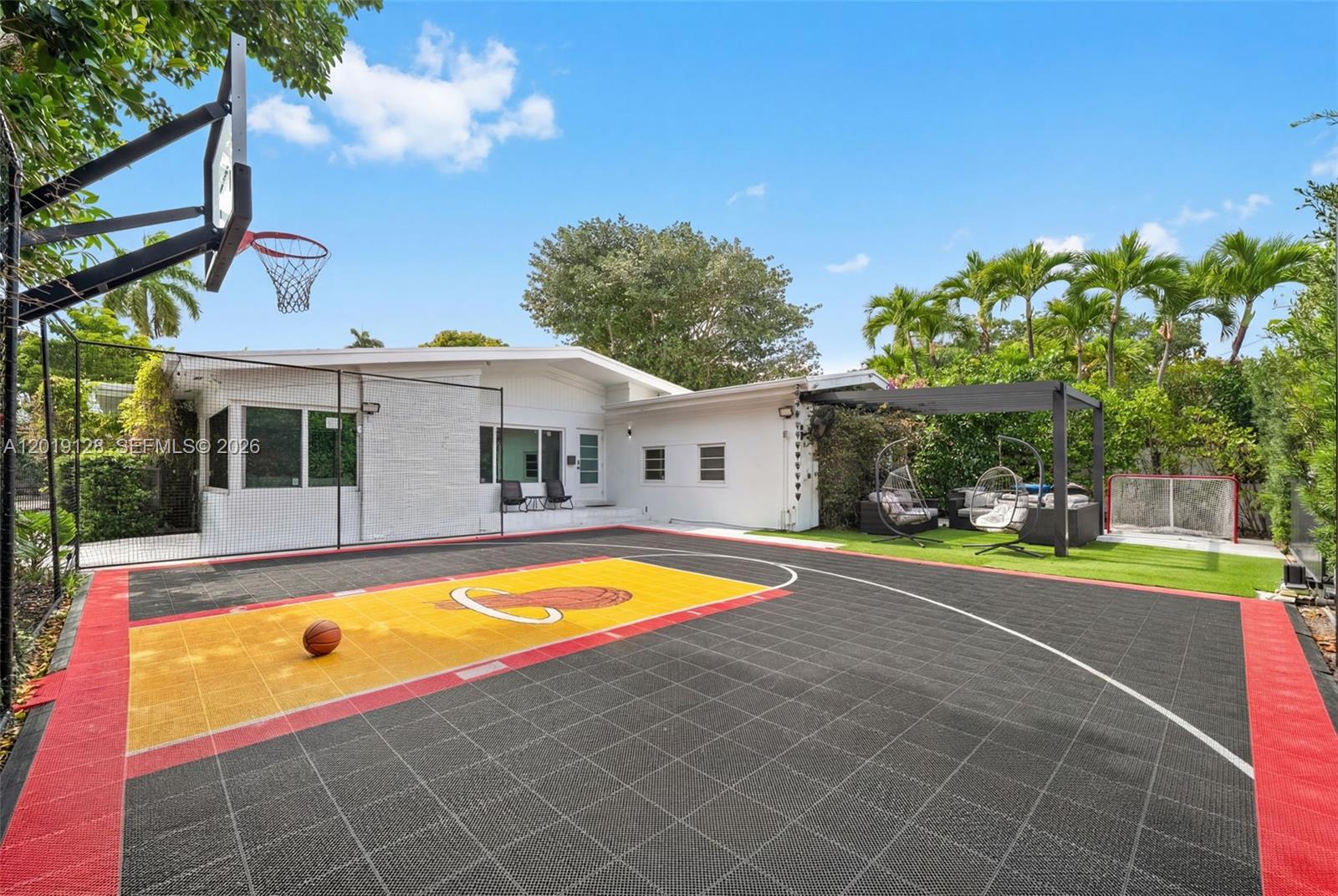 A backyard features a basketball court with a Miami Heat logo and a patio area — 3758 Prairie Ave, Miami Beach FL 33140, MIAMI BEACH, FL