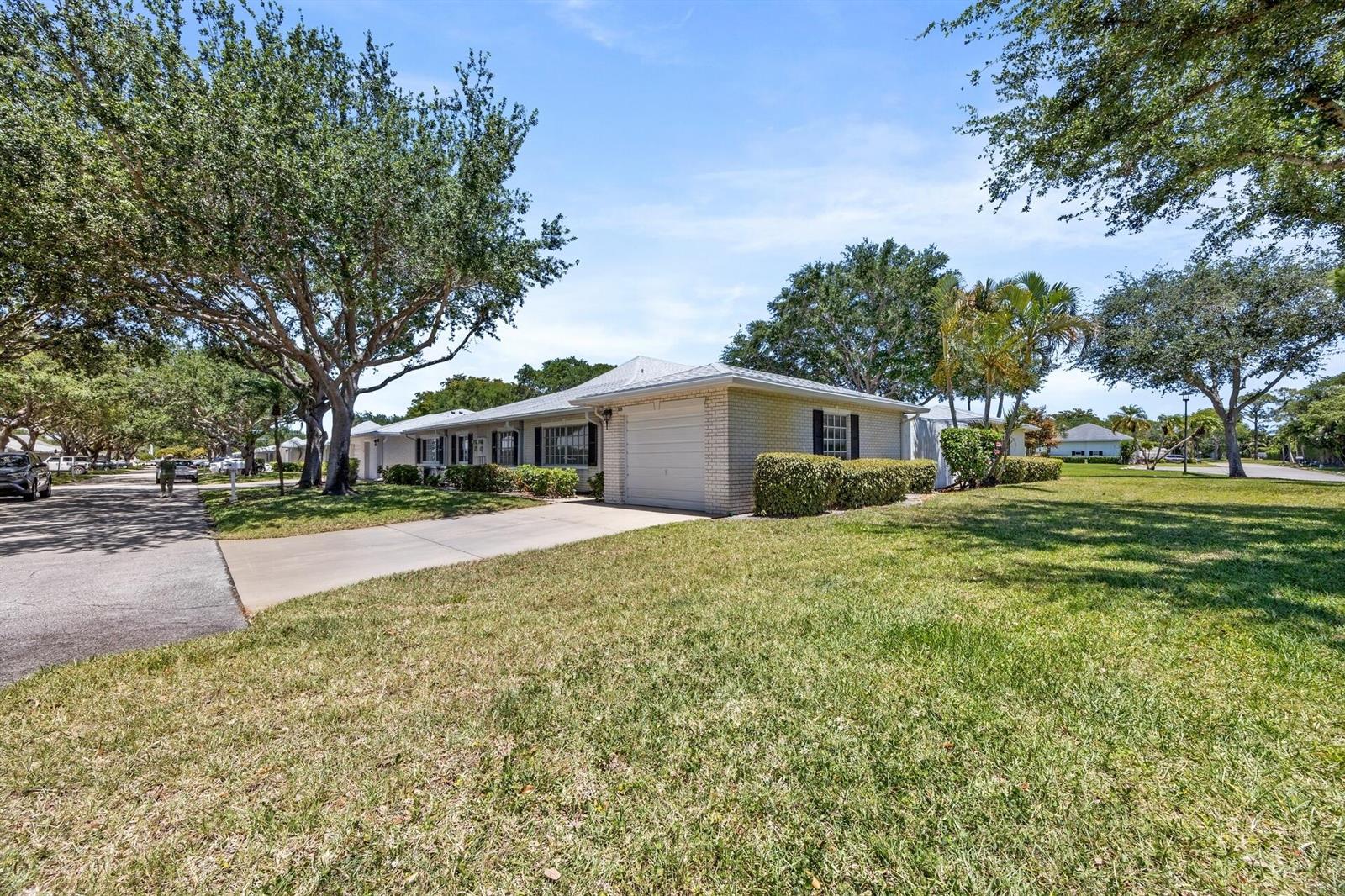 A single-story brick house with a garage and a large lawn under a blue sky — 10168 43rd Trail S # 318, Boynton Beach FL 33436, BOYNTON BEACH, FL