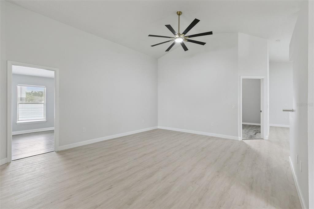 An empty room with light wood-look flooring, white walls, and a ceiling fan — 14426 LAKE PRICE DRIVE, ORLANDO, FL