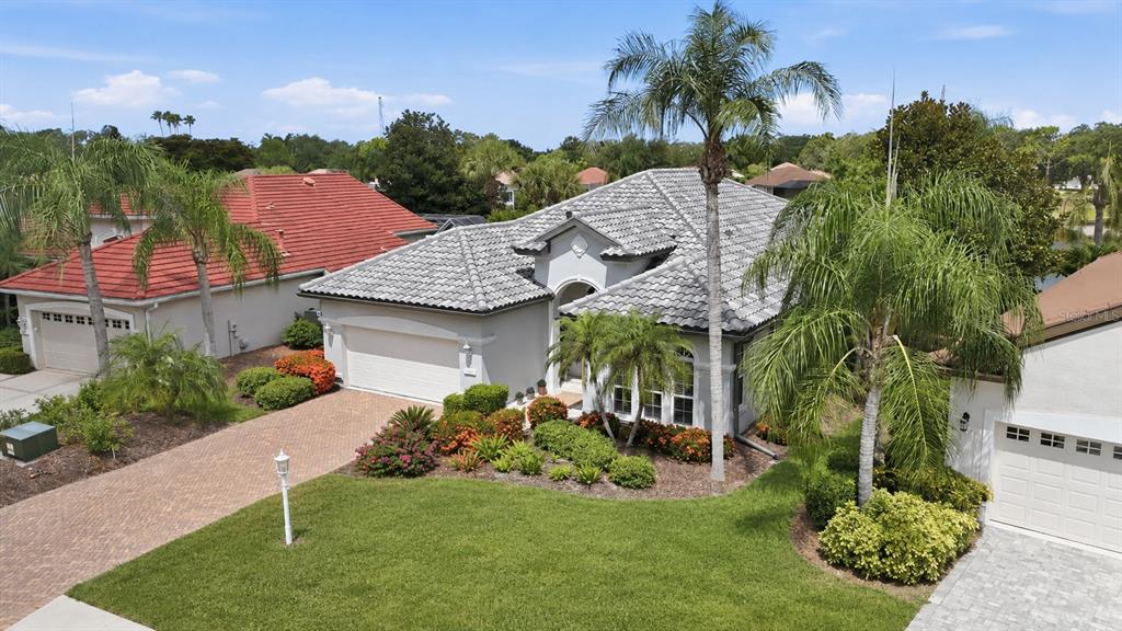 An aerial view of a single-story house with a gray tiled roof and palm trees — 7346 WINDEMERE LANE, UNIVERSITY PARK, FL