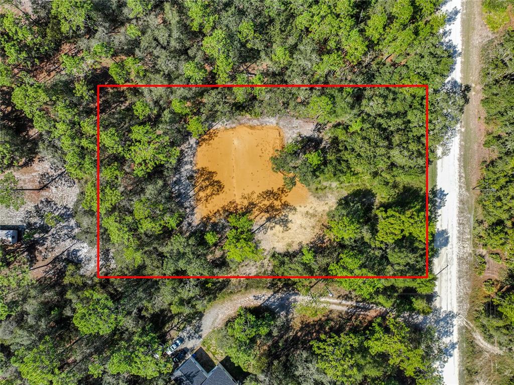 An aerial view shows a rectangular plot of land with a central cleared sandy area — 33216 TEAKWOOD DRIVE, WEBSTER, FL