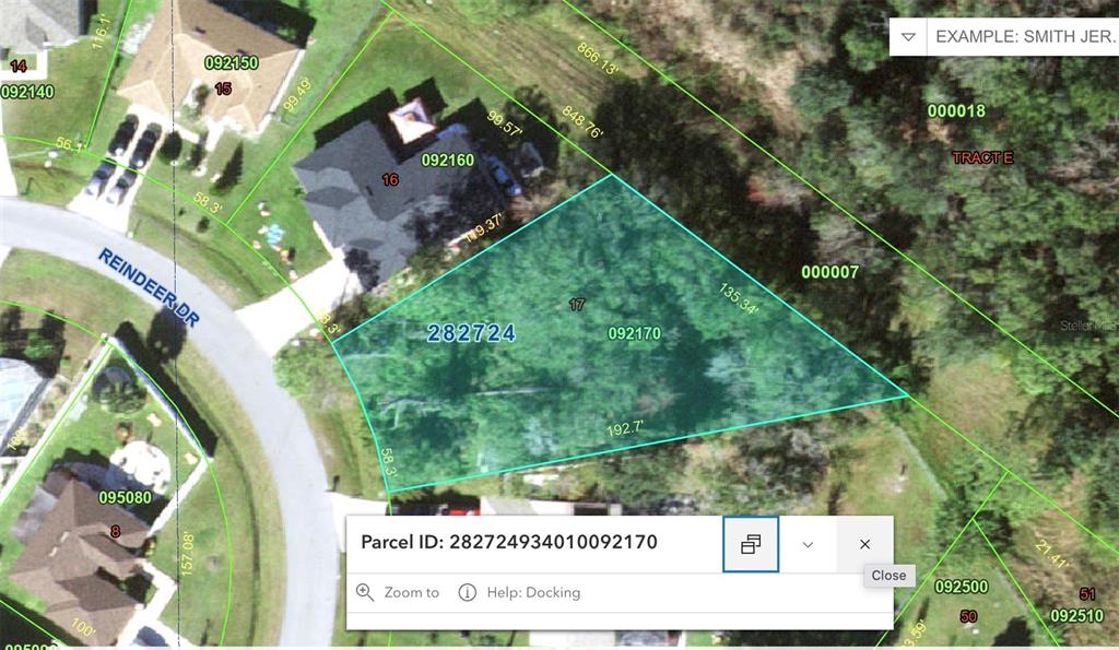 This is a satellite map showing a residential property parcel highlighted in blue — 656 REINDEER DRIVE, POINCIANA, FL
