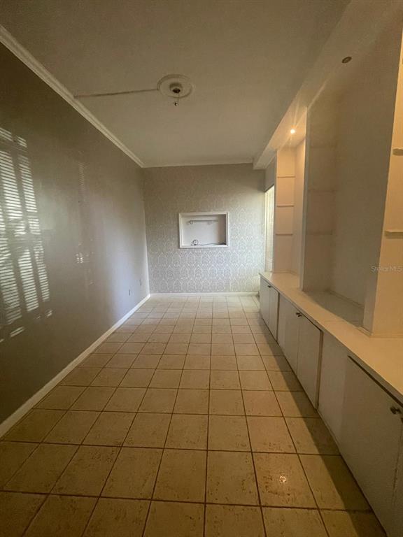 A narrow room with tiled flooring, built-in white cabinetry, and a recessed wall niche — 200 JESUS T PINEIRO AVENUE AVENUE, SAN JUAN, PR