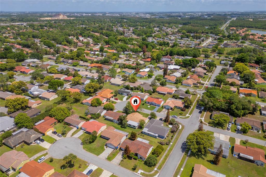 An aerial view shows a suburban neighborhood with many single-family homes and tree-lined streets — 10823 WILLIAM AND MARY COURT, ORLANDO, FL