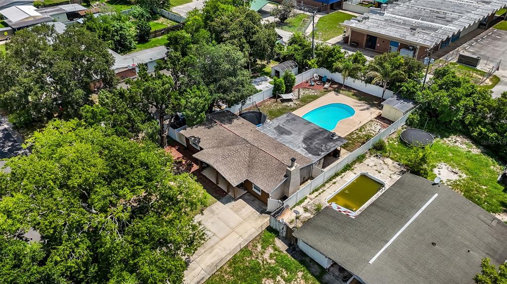 An aerial view shows a house with a swimming pool and a fenced backyard — 1509 PRIMROSE LANE, DAYTONA BEACH, FL