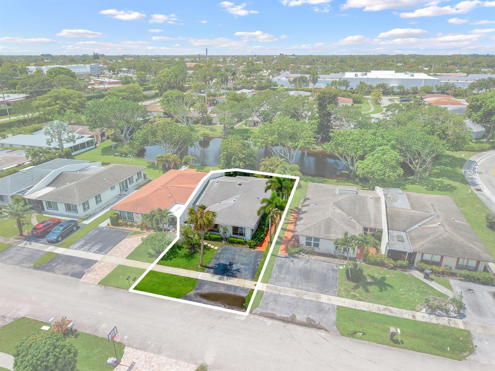An aerial view shows a single-story house with a driveway and lawn facing a street — 7543 Volley Place, Lake Worth FL 33467, LAKE WORTH, FL
