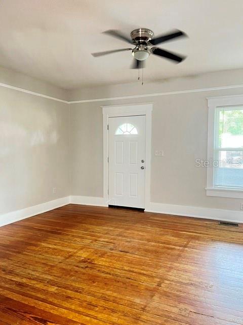 A room with light gray walls, hardwood floors, a ceiling fan, and a white door — 143 N STONE STREET UNIT N, DELAND, FL