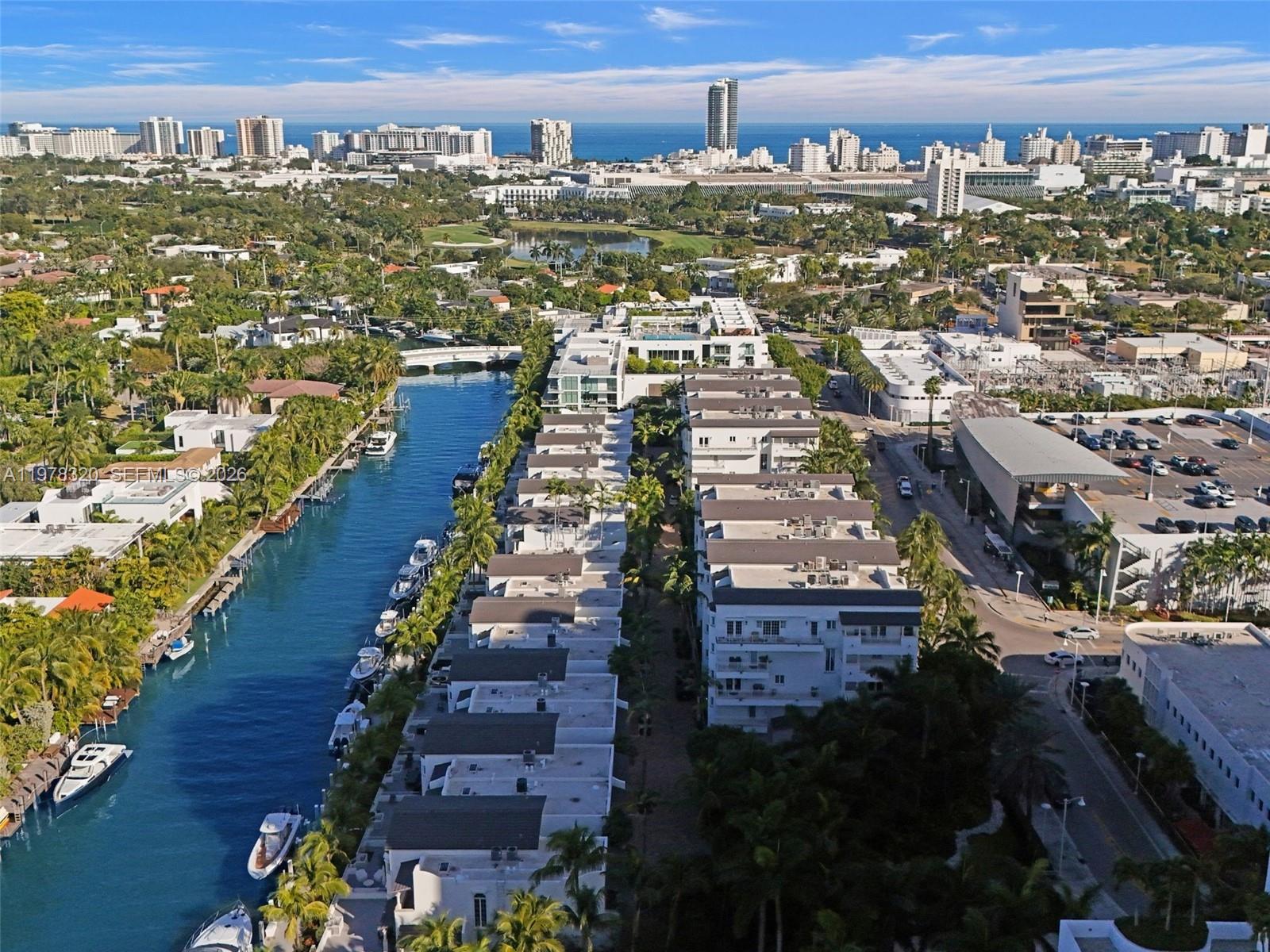 An aerial view shows a canal lined with boats next to a row of townhouses — 1415 Sunset Harbour Dr # 202, Miami Beach FL 33139, MIAMI BEACH, FL