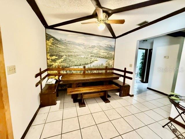 A dining area features a wooden table and benches against a mountain landscape wall mural — 1114 S PEARL STREET, DELAND, FL