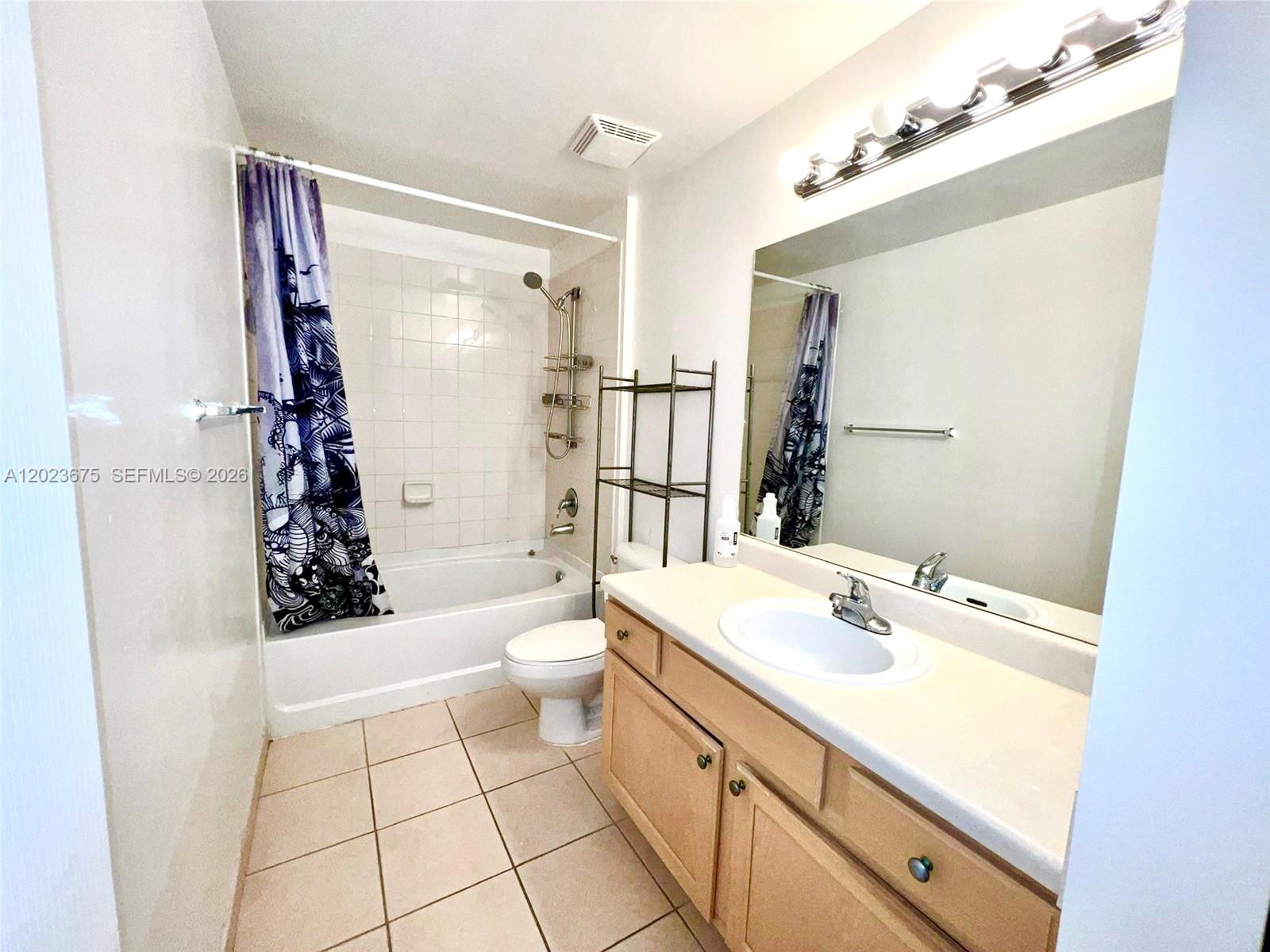 A bathroom features a vanity, a toilet, and a shower-tub combination with tiled walls — 6001 SW 70th St # 454, South Miami FL 33143, SOUTH MIAMI, FL