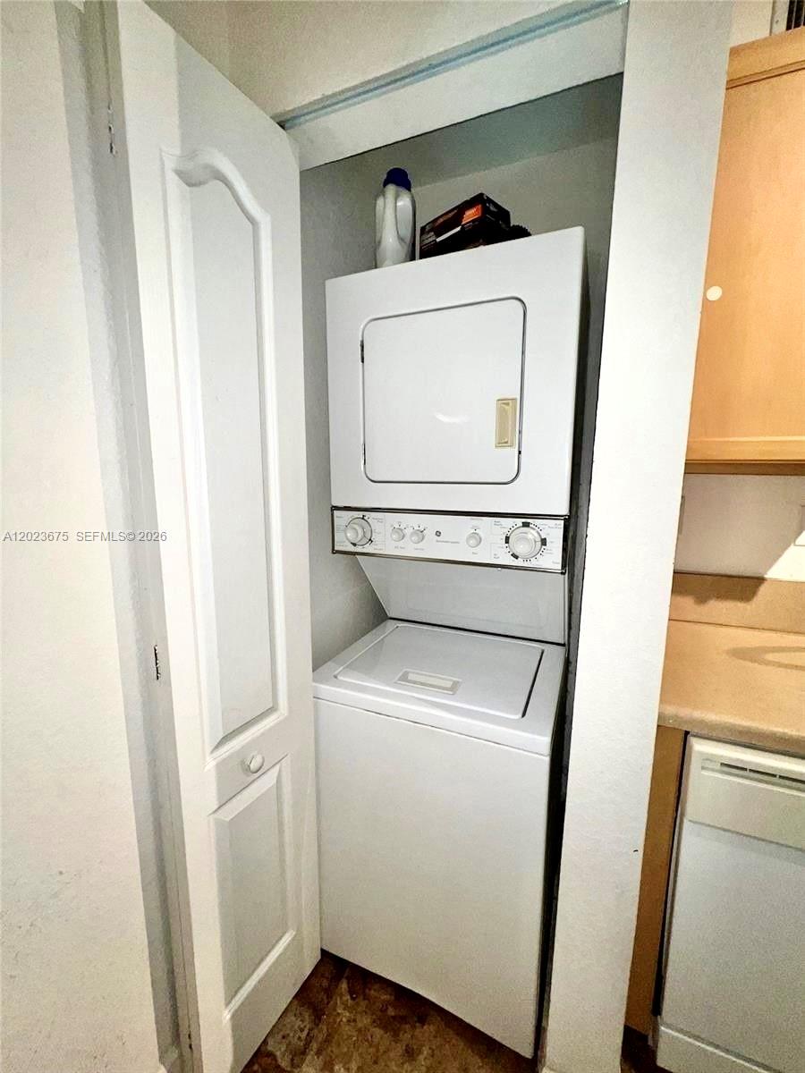 A stacked washer and dryer unit is installed in a small closet — 6001 SW 70th St # 454, South Miami FL 33143, SOUTH MIAMI, FL