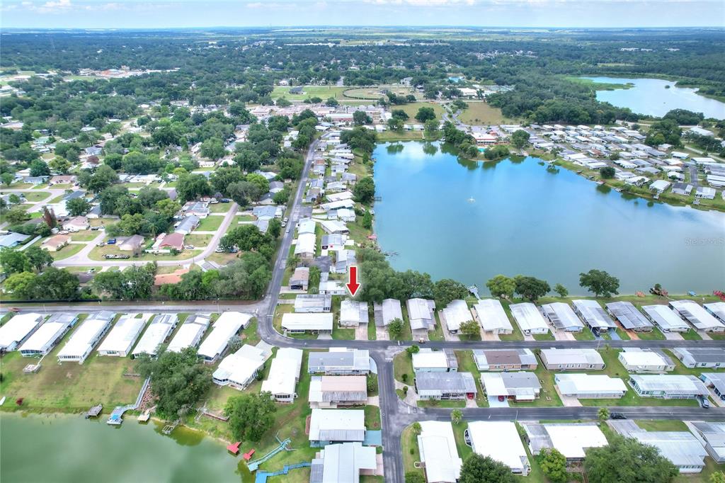An aerial view shows a mobile home community situated along a lake — 2055 S FLORAL AVENUE UNIT 296, BARTOW, FL