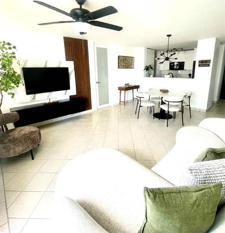 A living room and dining area feature tile floors, a ceiling fan, and modern furniture — 306 OCEAN WALK CHALETS, LUQUILLO, PR