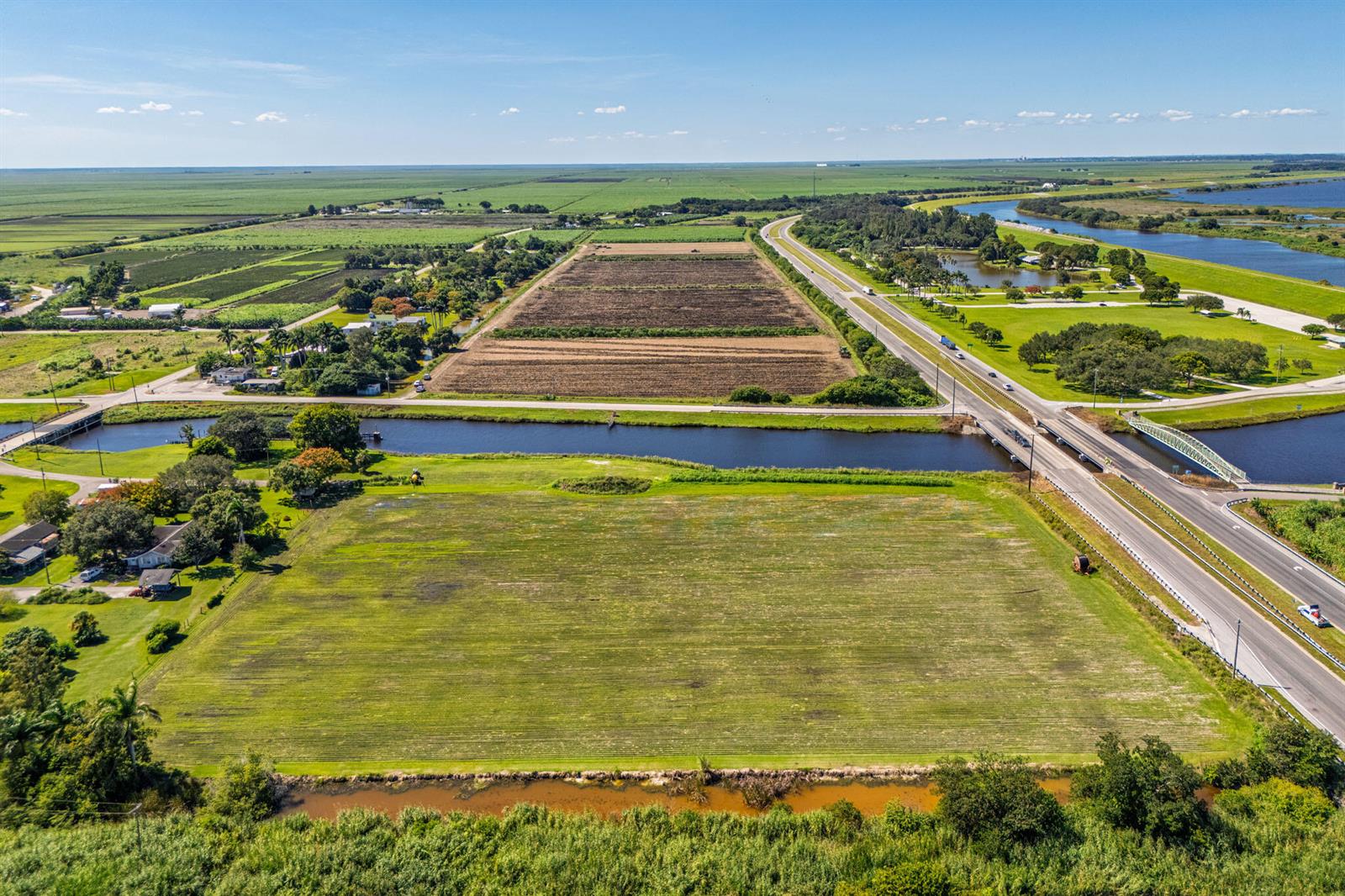 Aerial view of a large agricultural field adjacent to a highway and a canal — 0 Us-27, Clewiston FL 33440, CLEWISTON, FL