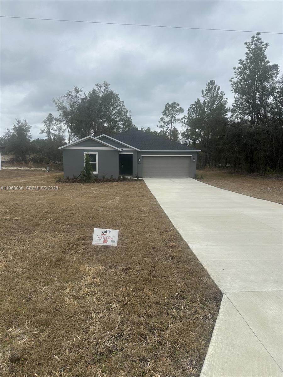 A single-story gray house with a two-car garage and a concrete driveway — 8934 SW 135TH ST, Ocala FL 34473, OCALA, FL