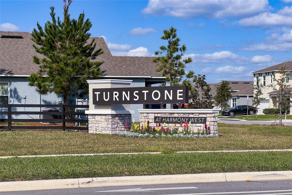A stone monument sign for Turnstone at Harmony West sits in a grassy residential area — 2653 HARMONIA HAMMOCK ROAD, HARMONY, FL