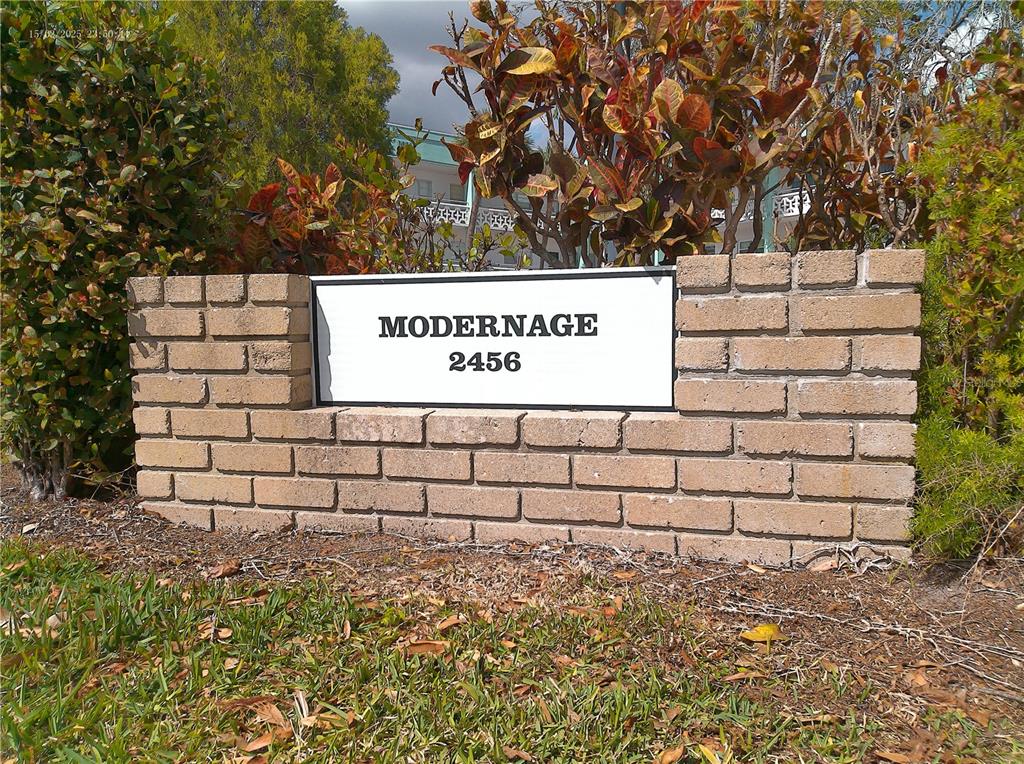 A brick monument sign displays the name Modernage and the number 2456 — 2456 ECUADORIAN WAY UNIT 38, CLEARWATER, FL
